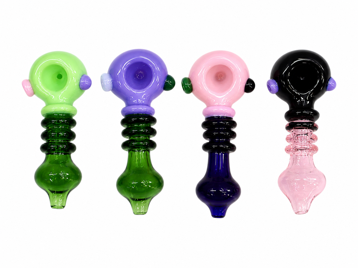 Four colorful glass water pipes in green, purple, pink, and black, arranged side-by-side on a plain white background.

