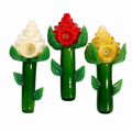 Three flower-shaped glass water pipes on a plain white background, featuring green stems and leaves with white, red, and yellow flower tops.

