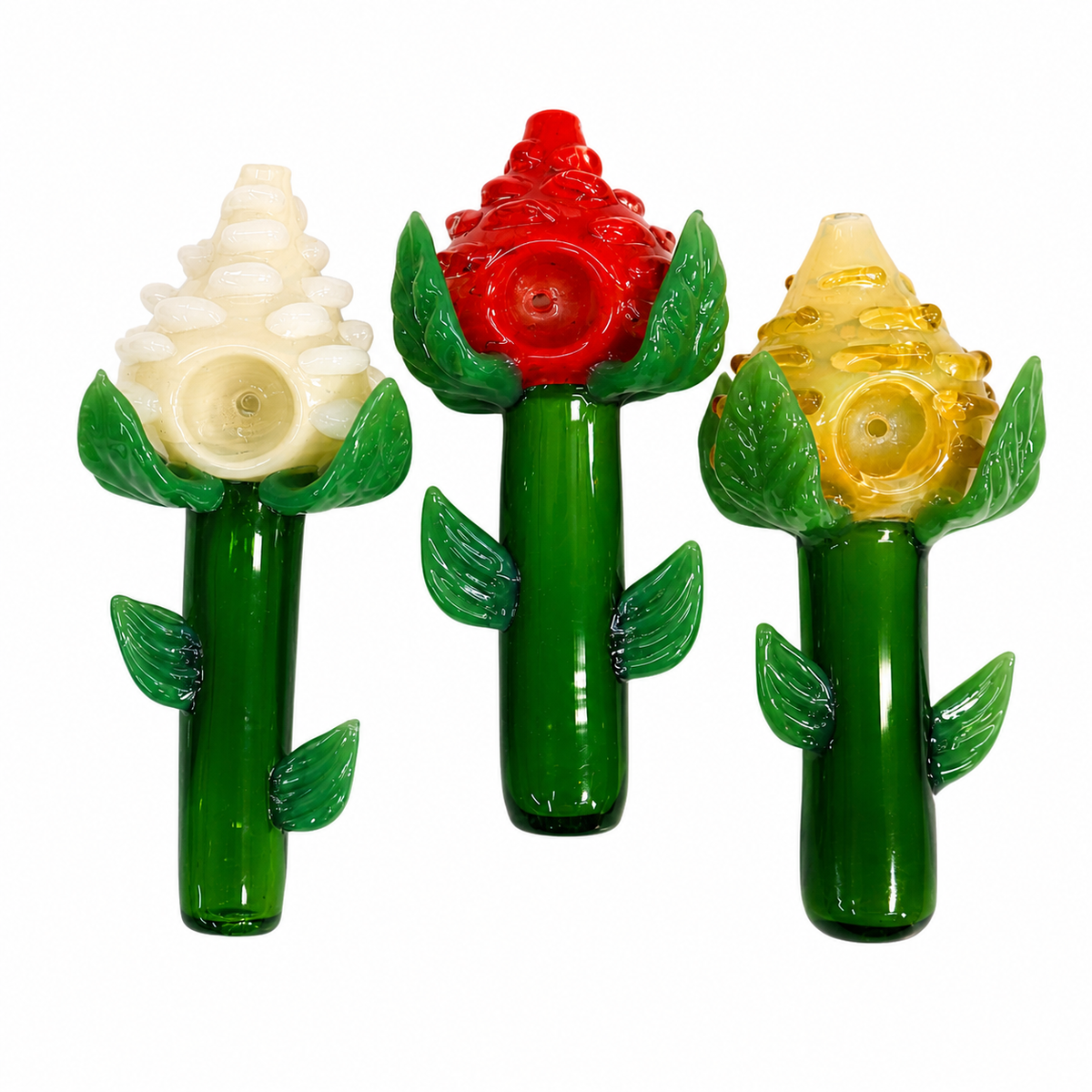 Three flower-shaped glass water pipes on a plain white background, featuring green stems and leaves with white, red, and yellow flower tops.

