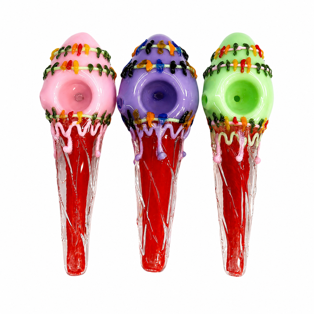 Three colorful glass ice cream cone-shaped smoking pipes on a plain white background, featuring pink, purple, and green tops with red bodies and decorative multicolor bead accents.

