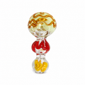 A hand-blown glass object with a bulbous, stacked design, featuring a top section with wavy amber-brown and pale yellow glass, a middle red glass section, and a bottom clear glass bulb containing yellow inclusions, set against a plain white background.

