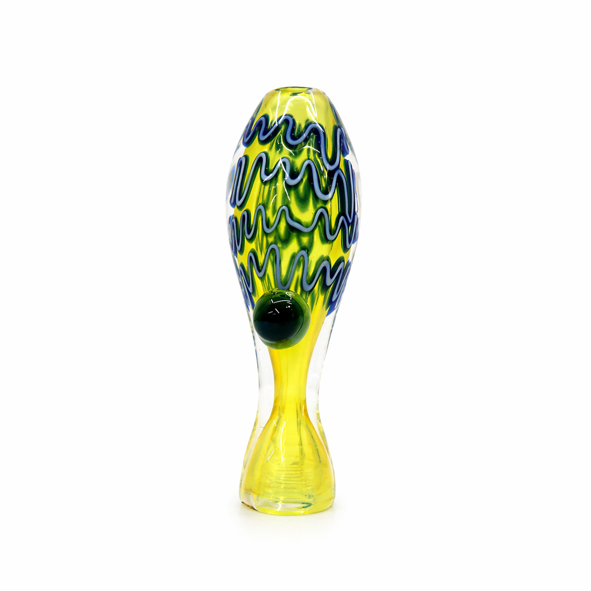 A hand-blown glass sculpture shaped like a stylized fish, featuring a vibrant yellow body with blue and green wavy patterns and a glossy black eye, set against a plain white background.

