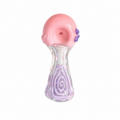 A hand-blown glass smoking pipe with a pink mouthpiece, purple accent beads, and a clear glass stem featuring a purple swirl pattern, isolated on a white background.

