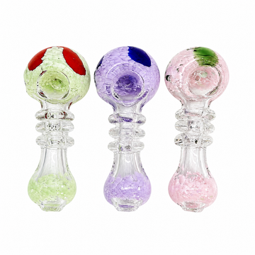 Three glass baby teething rings with textured, bubbly designs in green, purple, and pink, shown on a solid white background.

