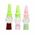 Three glass water pipe pieces with pointed tops, shown side by side on a white background. From left to right: one with a bright green top and dark brown base, one with a bright green top and pink base, and one with a pink top and light green base.