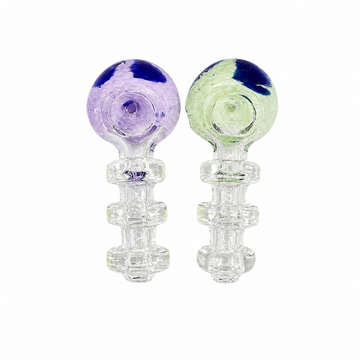 Two clear glass water pipes with spherical tops, one featuring purple and dark blue marbling, and the other featuring light green and dark blue marbling, set against a plain white background.

