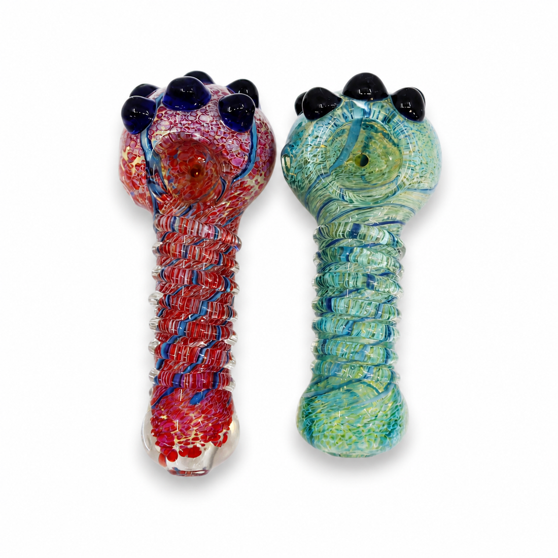 Two hand-blown glass water pipes with claw-shaped tops, one featuring a red, blue, and white marbled pattern, and the other in a green, blue, and yellow marbled pattern, set against a plain white background.